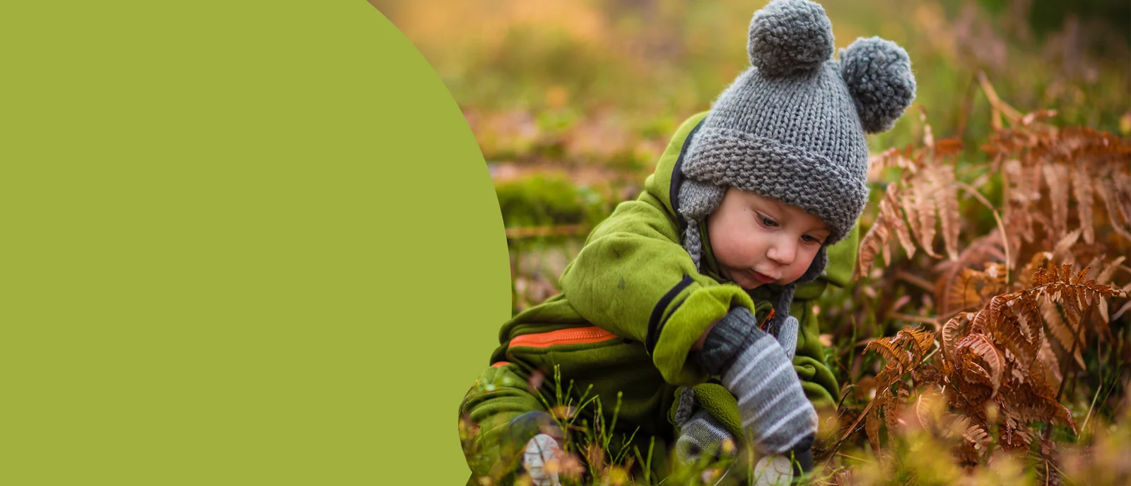 A little one in a soft knitted hat exploring outdoors
